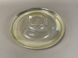a clear glass bowl with a silver rim on a table