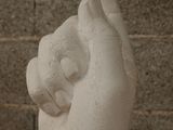 a clay sculpture of a hand holding a bird