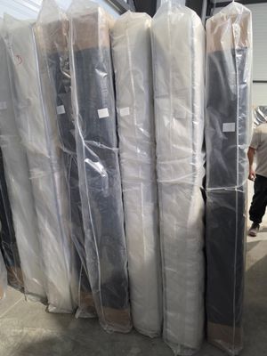 a lot of mattresses that are wrapped up and ready to be shipped