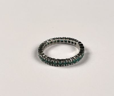 a close up of a ring on a table with a white background