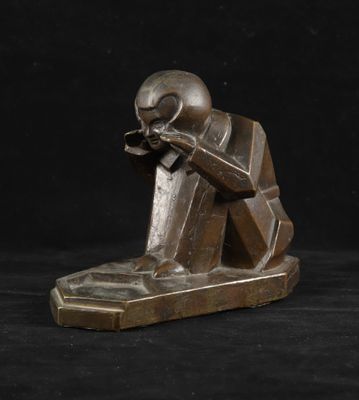 une photo d'une statue en bronze représentant un homme assis sur un banc