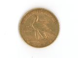 a gold coin with a bird on it on a white surface