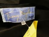 a close up of a person ' s hand holding a yellow piece of paper with a label on it