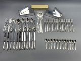 a lot of silverware on a table with a box