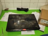 a laptop computer sitting on top of a green desk