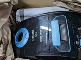 a black and blue radio sitting in a cardboard box