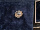 a blue velvet bag sitting on the floor next to a tv