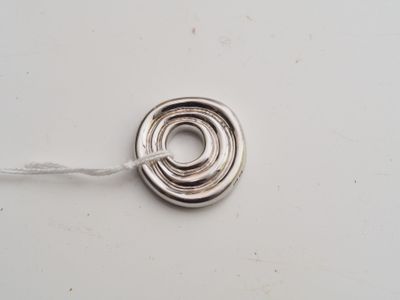 a close up of a metal object on a white surface