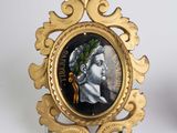 a gold frame with a picture of a man and a woman