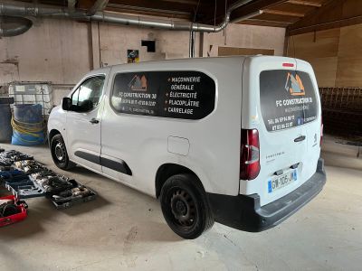 a van that is parked in a garage with tools on the floor