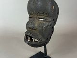 a close up of a mask on a stand with a white background