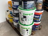 several buckets of paint are stacked on a pallet in a warehouse