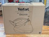 a box that is sitting on a table with a tea kettle