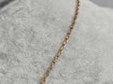 a close up of a gold necklace on a mannequin mannequin mannequin mannequin mannequin mannequin mannequin manne