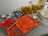 a table topped with silverware and glassware on top of a table