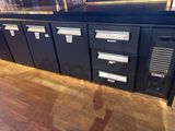 a black cabinet with four drawers and a computer on top of it