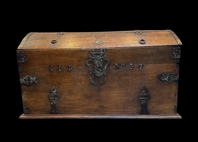 a wooden chest with metal decorations on it