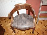 a wooden chair with a leather seat on a hard wood floor