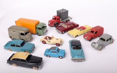 a lot of toy cars and trucks on a white surface