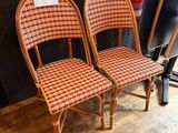 two wicker chairs with a price tag on the back of them