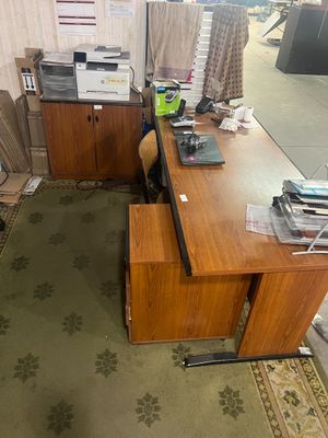 a desk with a chair and a computer on it