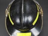 a close up of a fireman ' s helmet on a black background