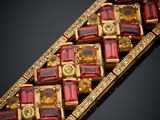 an image of a red and gold bracelet with a cross on it