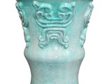 a blue vase with a decorative design on the outside of it