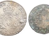 a silver coin with a crown on top and a crown on the bottom