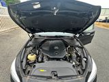 a car with its hood open on the street