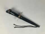 a black pen that is laying on a white surface