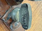 a close up of a rusted door handle on a wooden door