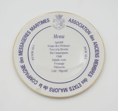 a plate with a menu on it sitting on a table
