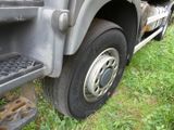 a close up of a truck tire on the grass