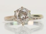 an image of a diamond ring on a reflective surface
