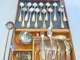 une boîte en bois contenant de l'argenterie et des cuillères