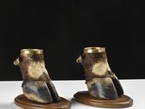 pair of animal foot shaped vases on wooden bases