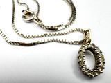 a silver necklace with a chain that has a ring on it