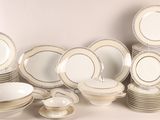 a lot of plates and bowls on the table