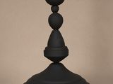 un vase noir posé sur une table en verre