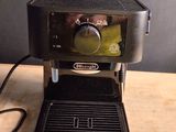 a coffee maker that is sitting on a wooden table