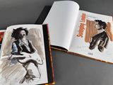 an open book with a drawing of a man playing a guitar
