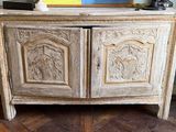 a white cabinet with carvings on it in the corner of a room