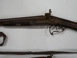 two old guns are on display on a white surface