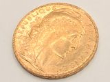 an image of a gold coin on a white surface