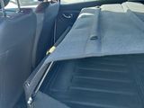 the back seat of a car with a car bed in the back of it