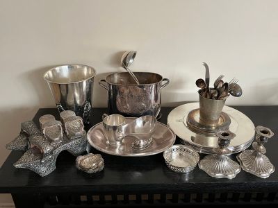 a black table with silver dishes and silverware on it