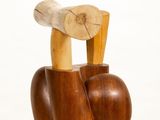 a wooden sculpture of an apple and a bird on top of it