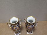 two vases that are sitting on a table