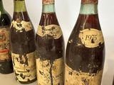 several bottles of wine are lined up on a table